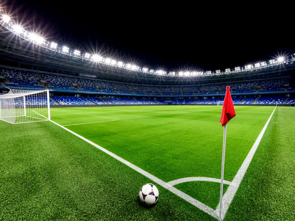 Upplyst fotbollsarena i kvällsmörker med grön plan, illustration till Champions League-kvalet