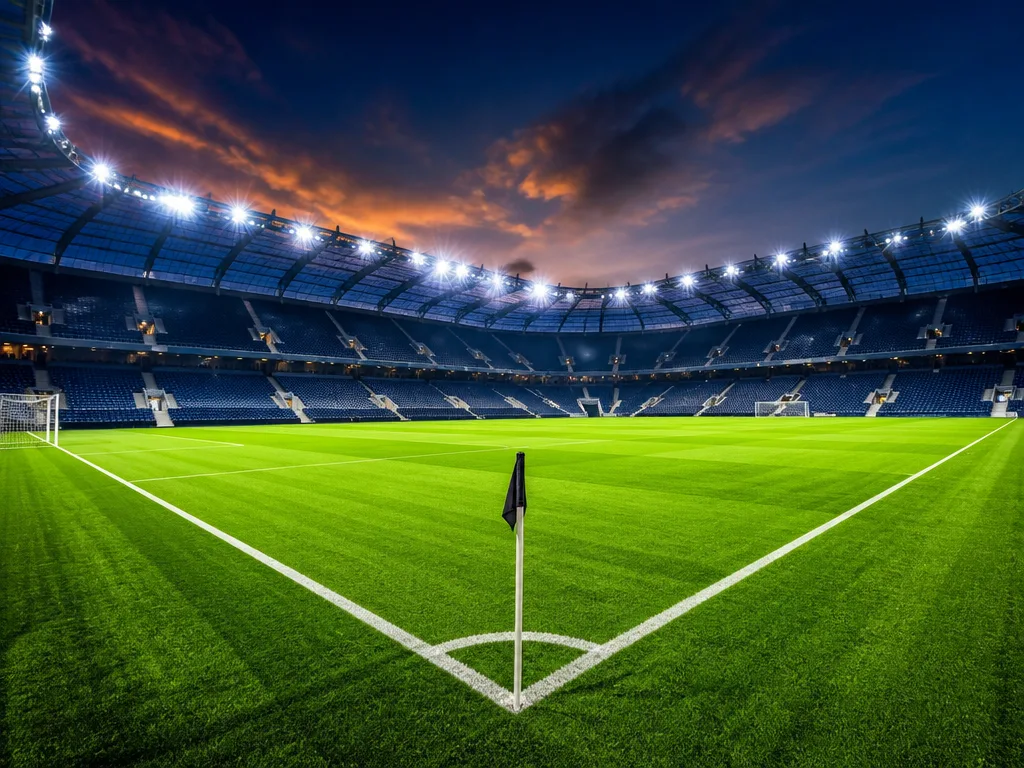 Upplyst fotbollsarena i skymning, symbol för Premier League och Liverpool